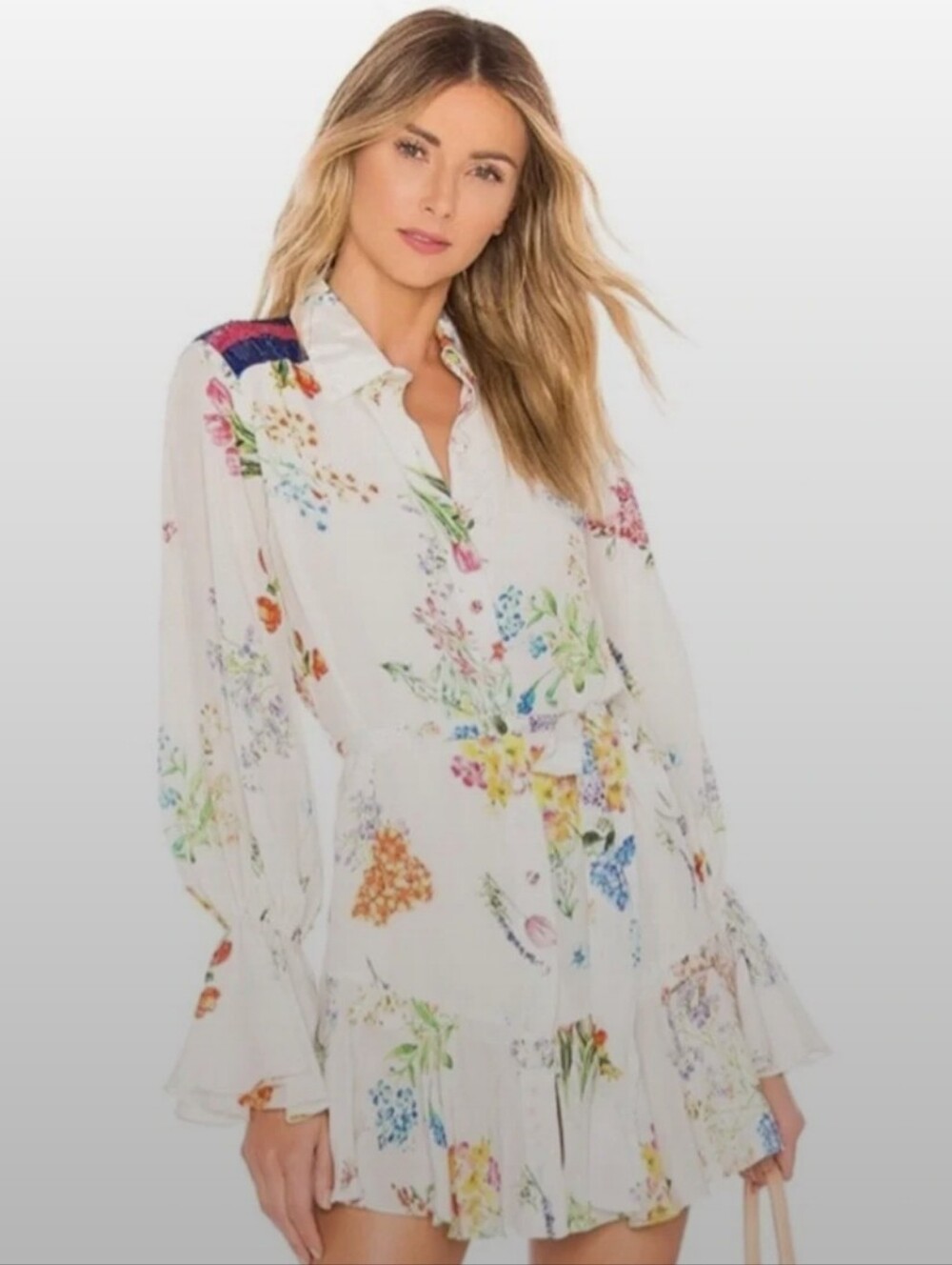 Rococo Sand decorated with a colorful floral pattern and a ruffled hem.